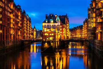 Fototapeta na wymiar Night view of Speicherstadt in Hamburg, Germany. Illuminated historical buildings