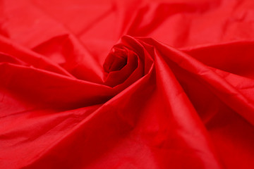 red fabric texture of background. Piece red fabric suitable for a textured background. Soft pleats on fabric