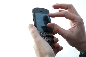 hand holding mobile phone isolated on white