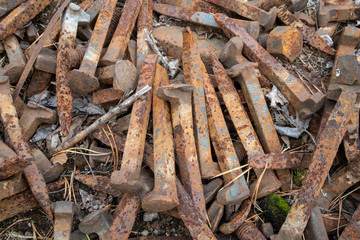 rusty railroad spikes on ground outdoors