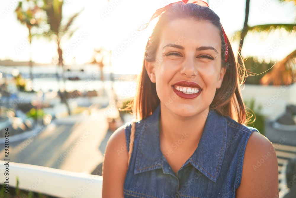 Wall mural Young beautiful woman smiling happy walking on city streets of Puerto de la Cruz, Tenerife on a sunny day of summer