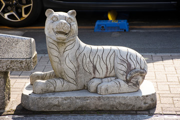 Traditional japanese style rock sculpture and carving as animal stone tiger one of 12 Zodiac at beside street at Narita old town in Tokyo, Japan