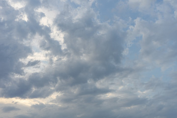 Blue sky background with big fluffy clouds. Dark sky with cloud before sunset