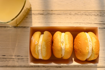 top view cakes with cream filling with cup of soy milk in a sunny morning