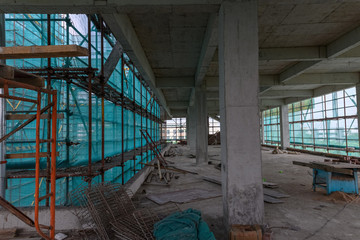 inside of an unfinished building with protection scaffolding and netting surrounded