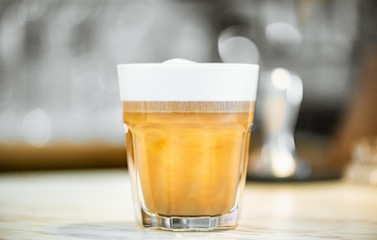 hands Barista steaming milk in pitcher.preparing steam milk by coffee machine to make latte art in cafe.latte is a coffee drink made from espresso and steamed milk.cup of latte coffee.