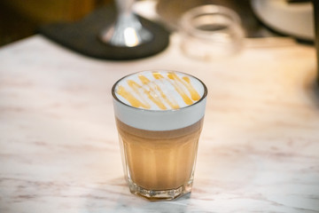 hands Barista steaming milk in pitcher.preparing steam milk by coffee machine to make latte art in cafe.latte is a coffee drink made from espresso and steamed milk.cup of latte coffee.