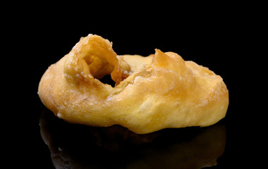 Chinese style deep fried doughnut with a bite on a black background