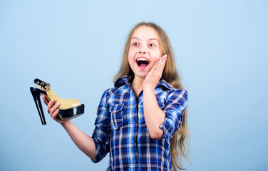 Female attribute. Play with moms shoes. Every girl dreaming about fashionable high heels. Little fashionista with high heels. Shoes shop. Fashion store. Boutique concept. Excited about high heels