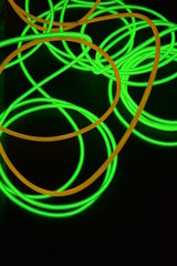 Bright luminous yellow and green, lime neon wires in different formats and layouts. An...