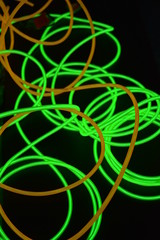 Bright luminous yellow and green, lime neon wires in different formats and layouts. An...