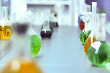 BLURRED laboratory background with glassware and colorful liquids. Science and education concept