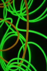 Bright luminous yellow and green, lime neon wires in different formats and layouts. An...