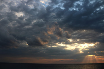 Dramatic stormy dark cloudy sky over sea 