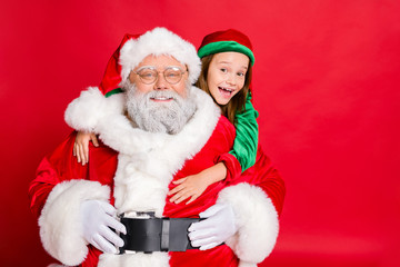 Close up photo of charming santa claus in eyeglasses eyewear and his little elf helper in green hat...