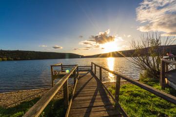 Views during the beautiful sunset on the dock for fishing of the Selga de Ordas reservoir in Leon, Spain