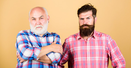 Hipster fashion. male beard care. checkered fashion. barbershop and hairdresser salon. two bearded men senior and mature. father and son family. youth vs old age compare. retirement
