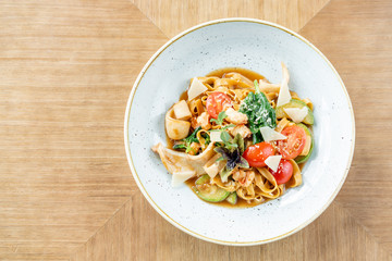 Italian pasta tagliatelle with seafood and tomato sauce. Pasta Gamberini. Parmesan cheese