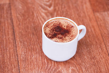 Coffee cup top view on old wooden