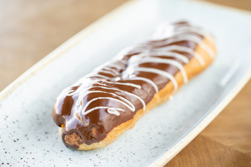 Traditional french eclairs with chocolate. Cake decorated with chocolate cream on top of are on a...