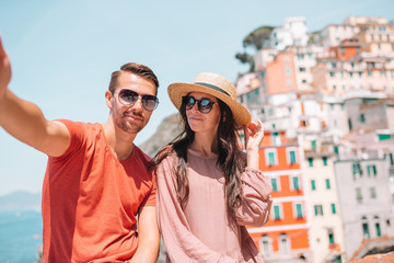 Fototapeta na wymiar Tourists looking at scenic view of Riomaggiore, Cinque Terre, Liguria, Italy