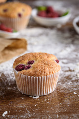 The process of making cupcakes, coating a cream from a pastry bag in the hands of a pastry chef.