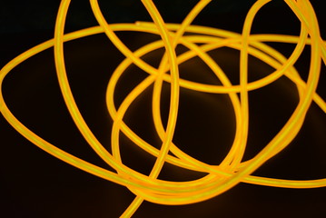Bright orange luminous wire, twisted light wire, cable. Different shapes and images of...