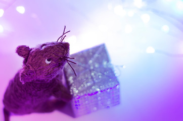 The toy mouse holds a gift. New Year 2020.