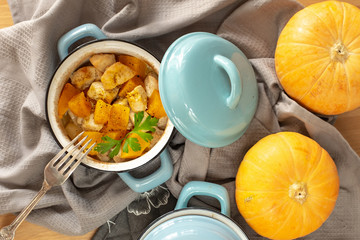 Pumpkin roast in a blue pan on a wooden table