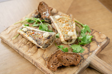 Beef bone marrow with chimichurri sauce and toasted bun. Served on a chopping wooden Board. Menu BBQ restaurant