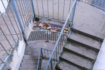 Flights of stairs in several floors for descent to the beach from the mountains. Old concrete gray...