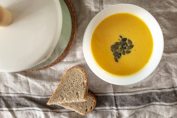 pumpkin cream soup with pumpkin seeds and bread