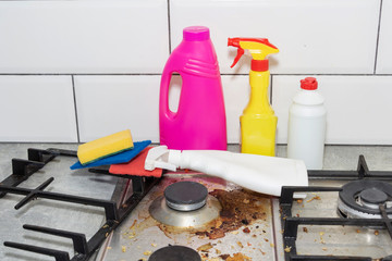 Dirty, top of the gas stove with bits of food. House cleaning.