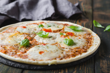 Thin pizza with mozzarella and basil