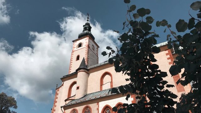 Tourist attraction - Church of the Assumption of the Blessed Virgin Mary. Old gothic church. Exterior in sunny day. Parish church.