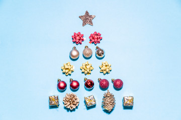 Christmas ornaments forming a Christmas tree on a blue background