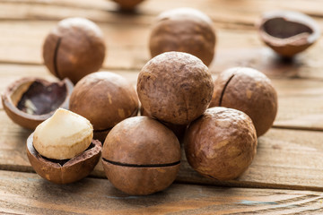 Macadamia nuts or bush nuts on the wooden table.