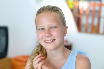 A teenage girl with a removable orthodontic appliance. Smiling with a bracket on her teeth. The...