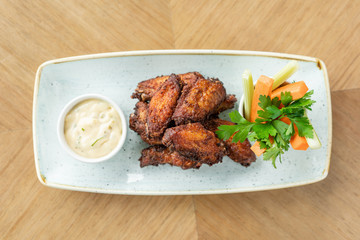 chicken wings grill. Serving on a white plate on a table. Barbecue restaurant menu, a series of photos of different meats
