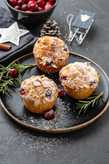 Muffins, cakes with cranberry, rosemary and almond nuts. Christmas decoration. Copy space.