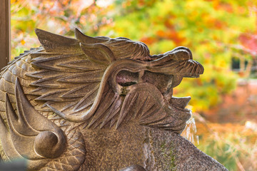 Stone dragon Zeniarai Benzaiten water purification basin in the inokashira park of Kichijoji city in autumn.