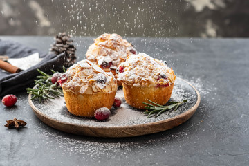 Muffins, cakes with cranberry, rosemary and almond nuts. Christmas decoration. Copy space.