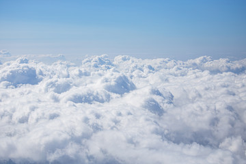 top view from airplane window of blue sky with cloudy background.