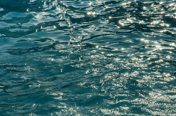 turquoise clear water in the sea. Background. Water plays in the sun.