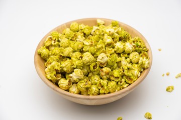 Japanese matcha green tea popcorn in the wooden bowl bulk isolated on white back ground