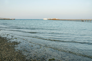 Red Sea coast and a yacht at sea far
