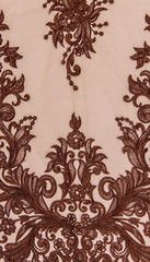 Texture lace fabric. lace on white background studio. thin fabric made of yarn or thread. a background image of ivory-colored lace cloth. Brown lace on beige background.