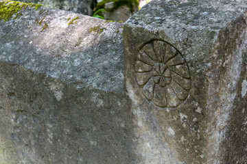 Ancient sign on the plate, located in the ancient cemetery.