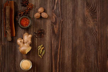 Spices for Masala tea are on the brown wooden table