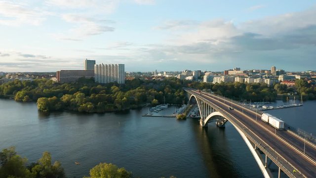 Aerial view Vasterbron bridge Stockholm Sweden, drone flies over traffic, water and cityscape